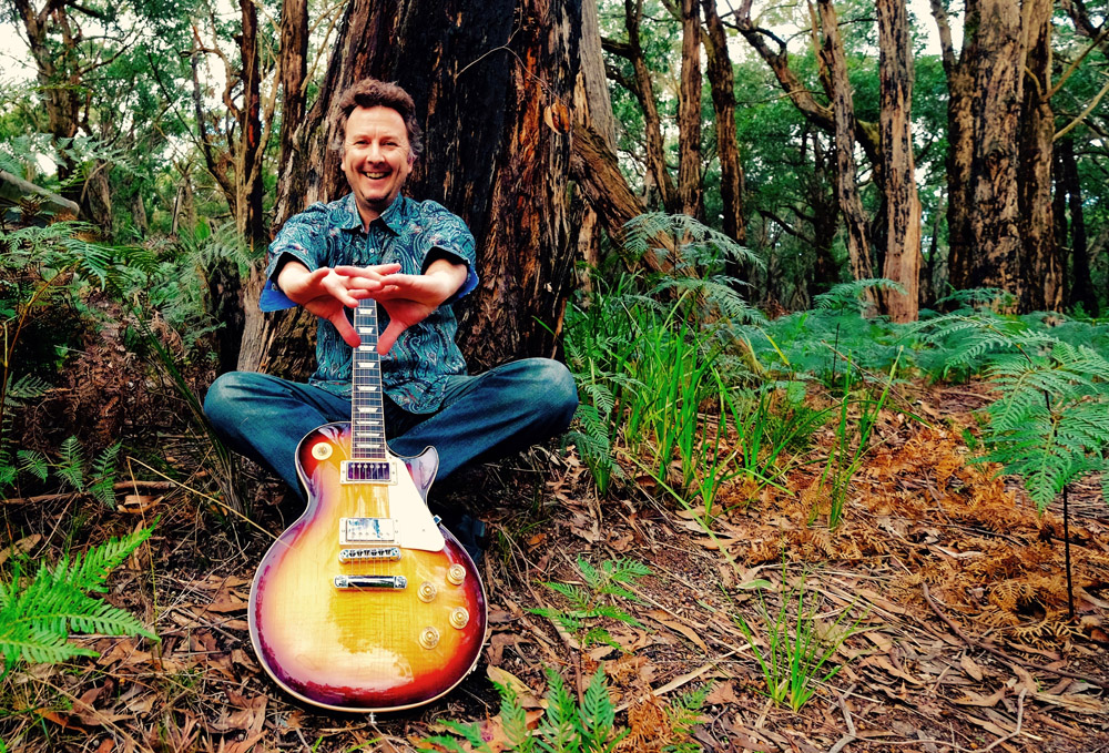 Patrick Shawcross with guitar, close portrait